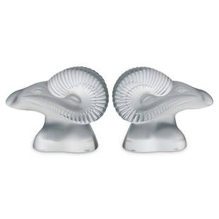 Lalique Crystal "Amon" Bookends: DESCRIPTION: Lalique crystal Amon bookends. Model #11855. This is a pair of matching frosted glass figurines depicting the head of ram. Signed with etched "Lalique France" signature. CIRCA: 20th Centu