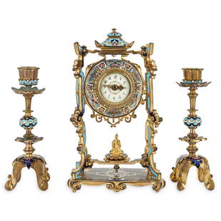 19th Century French Champleve Orientalist Clock Set: DESCRIPTION: Champleve bronze clock with matching candlesticks. Each piece is decorated with enameled orientalist floral motifs; curved feet; and an ornate, bronze frame. Clock has an image of