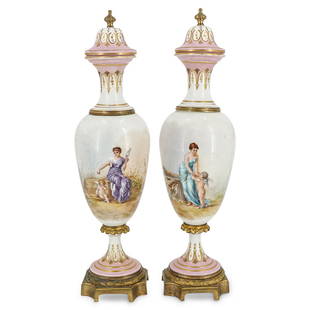 (2 Pc) French Sevres Fond Rose Pink Urns: DESCRIPTION: A pair of antique French Sevres fond rose pink urns decorated with hand-painted scenes depicting a classical female figure with putti against a garden landscape background. Each scene is