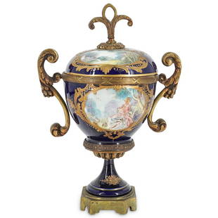 German Porcelain Cobalt Blue Lidded Urn: DESCRIPTION: A lidded, handled, porcelain urn with a signed hand-painted central scene depicting a young elegant girl seated in a garden. Central image is against a blue ground, and piece further