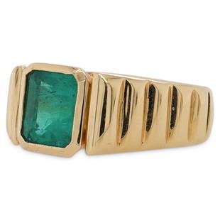 18k Gold and Emerald Ring: DESCRIPTION: A 18k gold ring features a Jubilee setting set with an approx. 3ct Rectangular cut Colombian Emerald , accented along the shoulders with incision lines. Stampe along the inner band "18K".