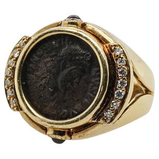 Italian 18k Gold Ancient Roman Coin Ring: DESCRIPTION: An Italian 18k gold ring features an encased Ancient Roman Coin, encompassed by two strips of diamonds on either side and sapphire accents. Stamped along the inner band "Italy 18k".