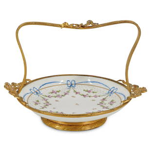 Sevres Bronze Mounted Porcelain Basket: DESCRIPTION: Sevres French gilt bronze mounted porcelain basket with floral and ribbon motifs. Signed with underglaze "S" markings. CIRCA: Late 19th Cent. to Early 20th Cent. ORIGIN: France