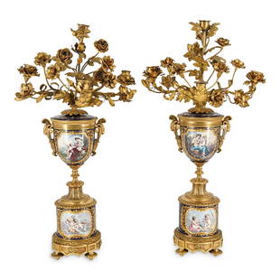 Pair of Cobalt Blue Sevres Candelabras: DESCRIPTION: French Sevres gilt bronze mounted, cobalt blue porcelain candelabras. Each features hand painted maiden and cherub portraits with landscape scenes, designed with double figural goat mask