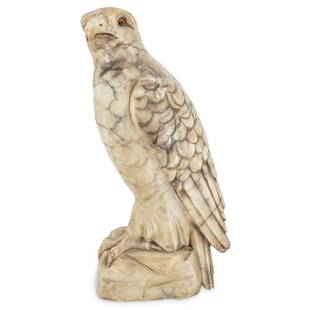 Alabaster Falcon Sculpture: DESCRIPTION: Alabaster sculpture of a falcon with detailed wings, talons, and tail feathers and orange glass eyes. CIRCA: Early to Mid-20th Century ORIGIN: European DIMENSIONS: H: 15.75" W: 8.5" L: