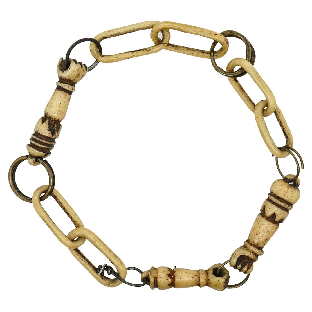 19th Century Napoleonic Prisoner Of War Bone Bracelet: DESCRIPTION: Prisoner of war bracelet the links of which are fashioned from bent metal and carved bone. Three of the links are shaped like fists clutching the attached metal links. CIRCA: 20th Century