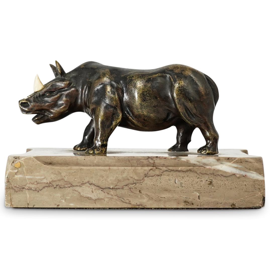 French Bronze Rhinoceros: DESCRIPTION: A French rhinoceros statue composed of bronze with bone carved horns, mounted to a grey marble base. CIRCA: Early 20th Cent. ORIGIN: France DIMENSIONS: H: 4" x W: 4" x L: 6" CONDITION: On