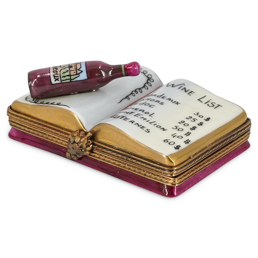 Limoges Porcelain Wine List Trinket Box: DESCRIPTION: A Limoges porcelain painted trinket box depicting a wine list brochure, and a wine bottle. Marked with "Limoges Peint Main France" signature. CIRCA: 20th Century. ORIGIN: France. DIMENSIO
