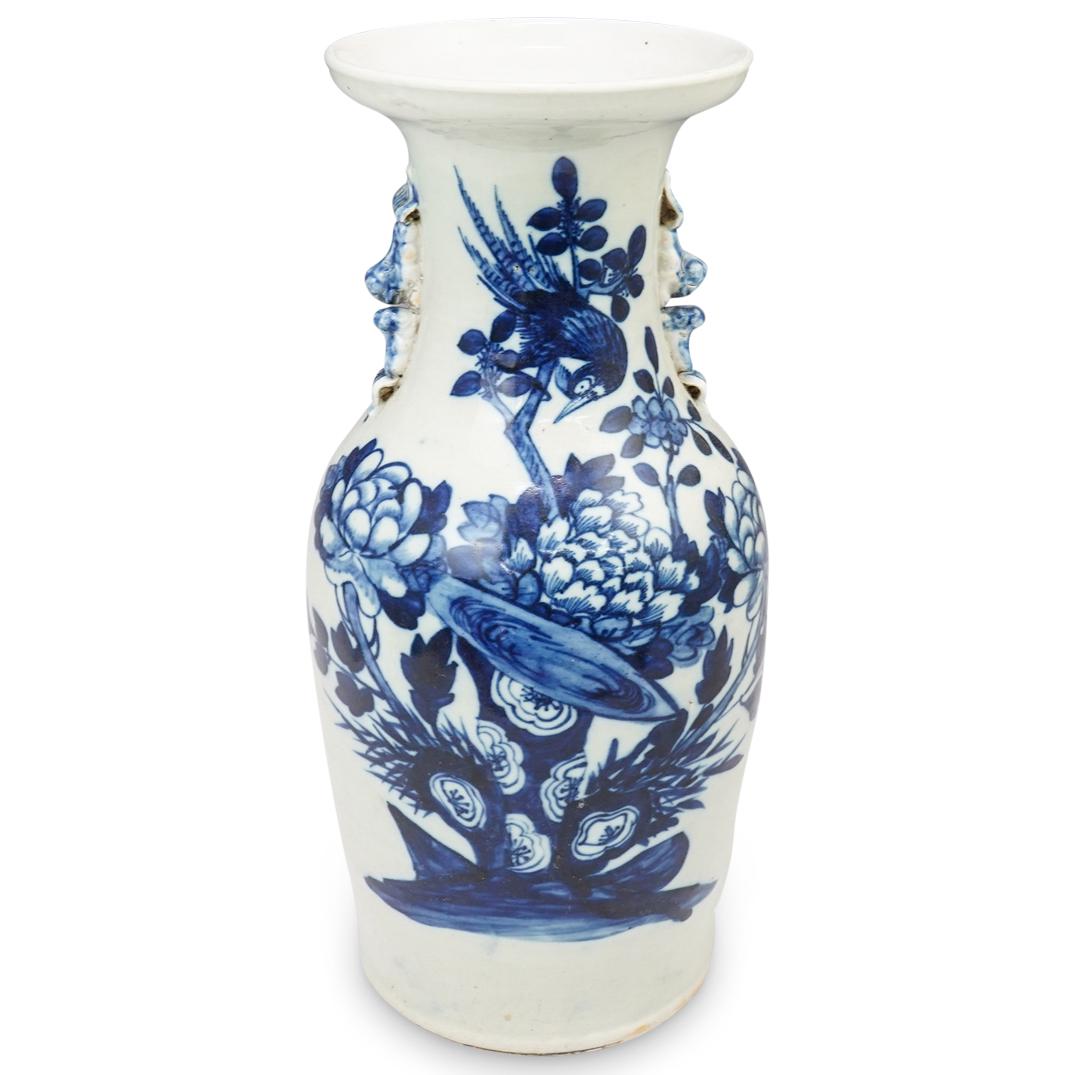 Chinese Blue and White Porcelain Vase: DESCRIPTION: A Chinese Blue and White porcelain vase features floral decorations with a bird motifs, flanked on either side with foo dog handles. CIRCA: Early 20th Cent. possibly older ORIGIN: China D