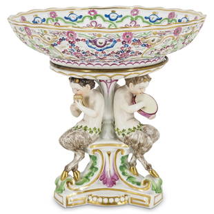 Meissen Porcelain Centerpiece Footed Fruit Bowl: DESCRIPTION: A Meissen centerpiece footed fruit bowl, supported by three sculptured satyr figurines, playing musical instruments. The circular bowl features a pierced reticulated body with floral moti