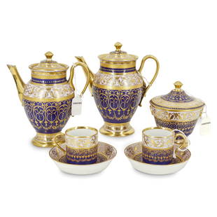 Ex Christie's 19th Cent. Vienna Porcelain Tea Set: DESCRIPTION: (7Pc) Ex. Christie's 19th Cent. Vienna porcelain tea service, features dark purple with ornate gilt raised scrolling and floral designs throughout. Marked with underglaze blue beehive