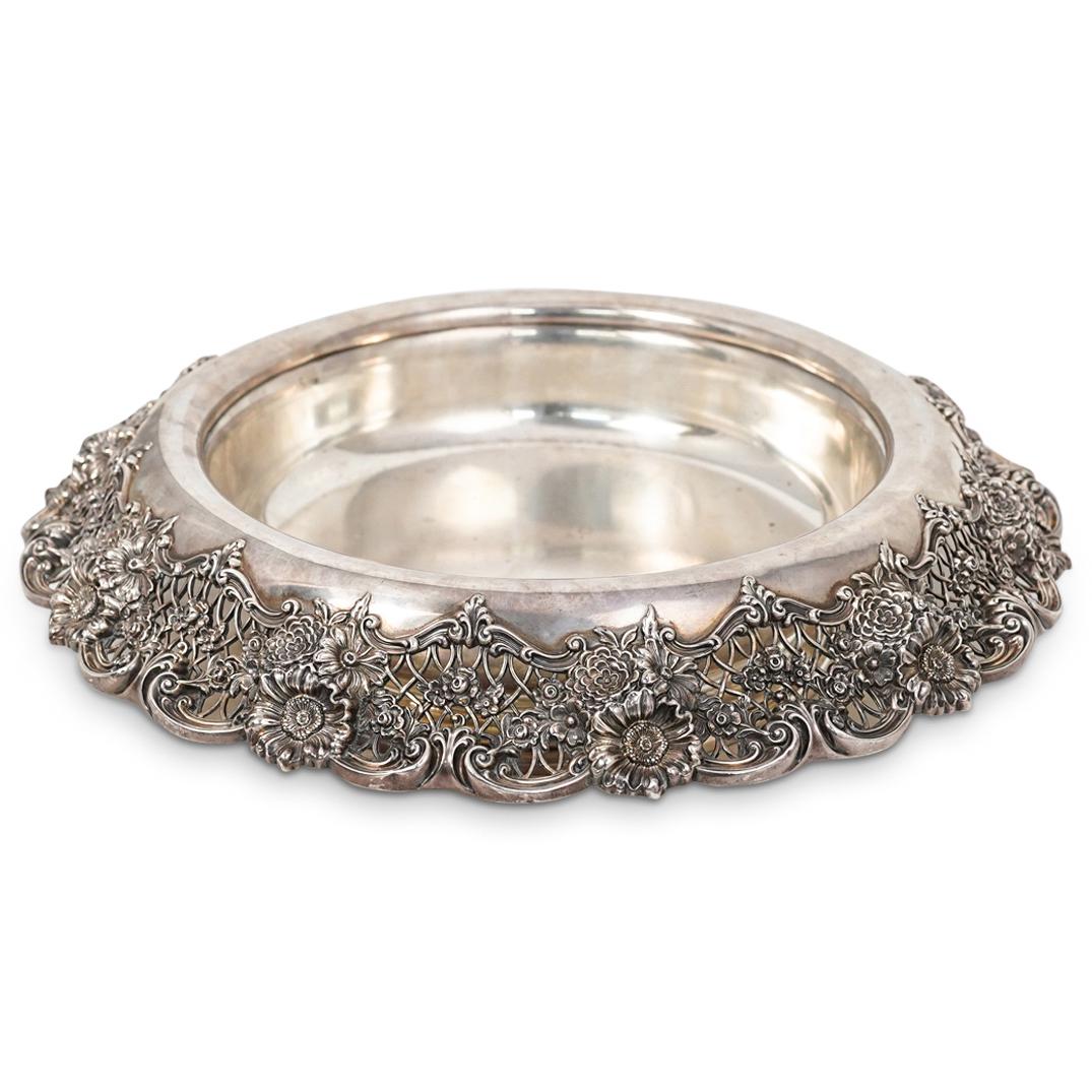 Large Sterling Centerpiece Bowl: DESCRIPTION: A sterling silver centerpiece bowl with open-work floral decoration and round pedestal base. Stamped. "Sterling, 750, 16 1/2" with diamond shaped pictorial mark. CIRCA: 20th Century. ORIG