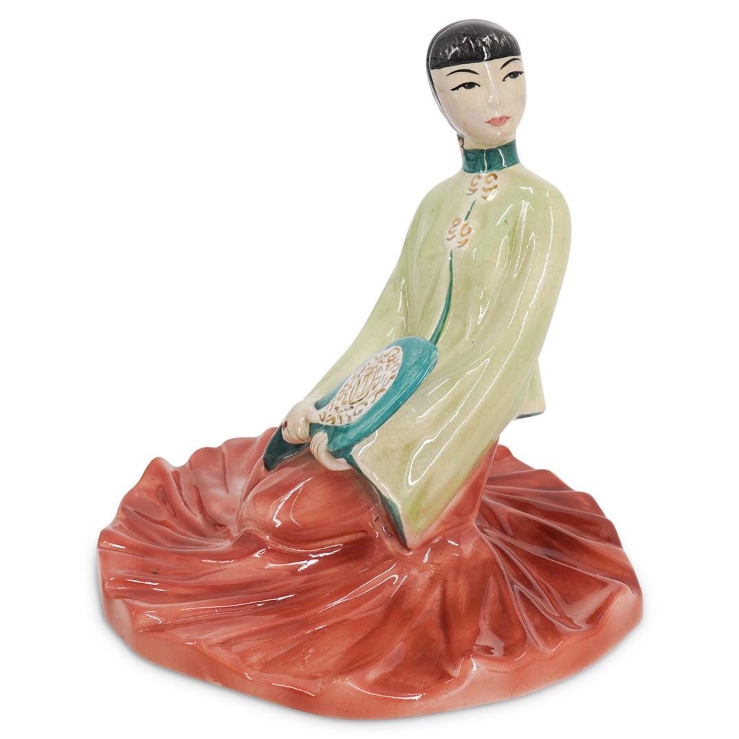 Porcelain "Chinese Princess" Sculpture: DESCRIPTION: Porcelain sculpture entitled "Chinese Princess" by Barbara Loveday depicting a seated Chinese woman in a long dress holding a fan. Piece is embellished with gilt accents throughout and fl