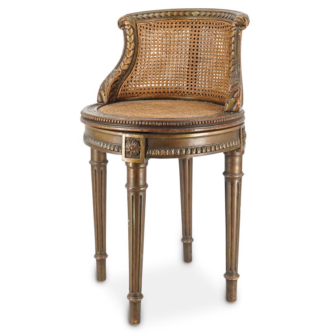 Revolving Wicker Piano Chair: DESCRIPTION: Wicker revolving piano chair with double-layer of wicker and a carved foliage motif along its frame. Chair has four legs above three of which is a carved floral decoration. Legs are decor