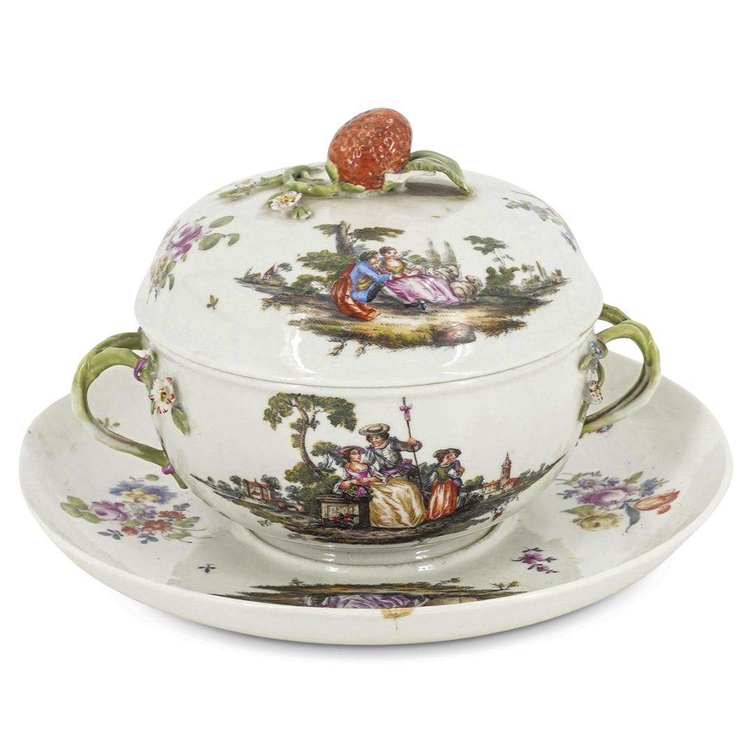 Meissen-Style Lidded Bowl With Underplate: DESCRIPTION: Lidded, double-handled bowl with underplate featuring on foliage-form handles, floral-form embellishments, and a strawberry finial. Lid, bowl, and underplate are each decorated with image