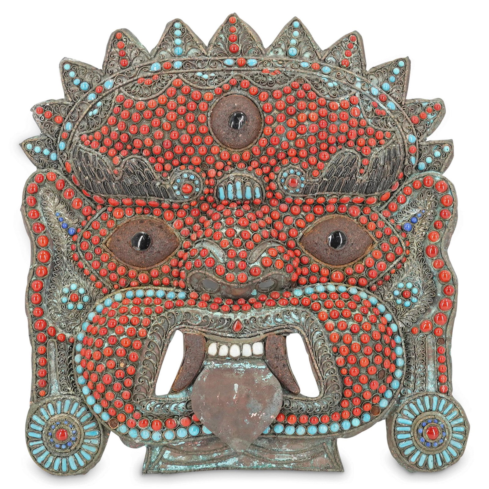 Nepalese Brass Hanging Demon Mask: DESCRIPTION: Brass mask depicting a demon's face decorated with blue, light blue, red, and dark purple beads. Piece has a loop on the back for hanging the mask. CIRCA: 20th Century ORIGIN: Nepal DIMEN