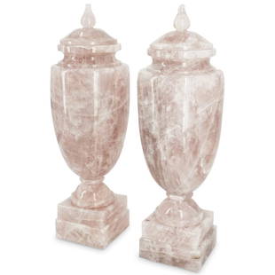 Pair of Mid Century Modern Rose Quartz Carved Urns: DESCRIPTION: A pair of French mid century modern carved rose quartz crystal urns with Neo-Classical forms, raised on square, tiered bases. CIRCA: Mid 20th Cent. ORIGIN: France DIMENSIONS: H: 22.25" x