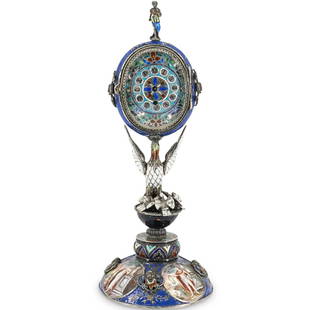 Hermann Bohm Viennese Silver Enamel Figural Clock: DESCRIPTION: Hermann Bohm Viennese silver enamel clock, featuring a naturalistic feeding bird supporting an oval clock case atop a tapered geometric engraved stem, finished on a hand painted Roman Gre