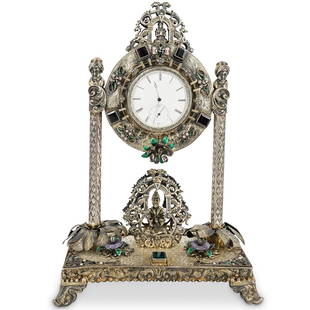 19th C. Viennese Enameled Silver Clock: DESCRIPTION: Viennese, orientalist silver clock featuring enameled and jeweled floral designs on its base, a pair of palm-form columns holding the clock face and movement, and a central sage figure se