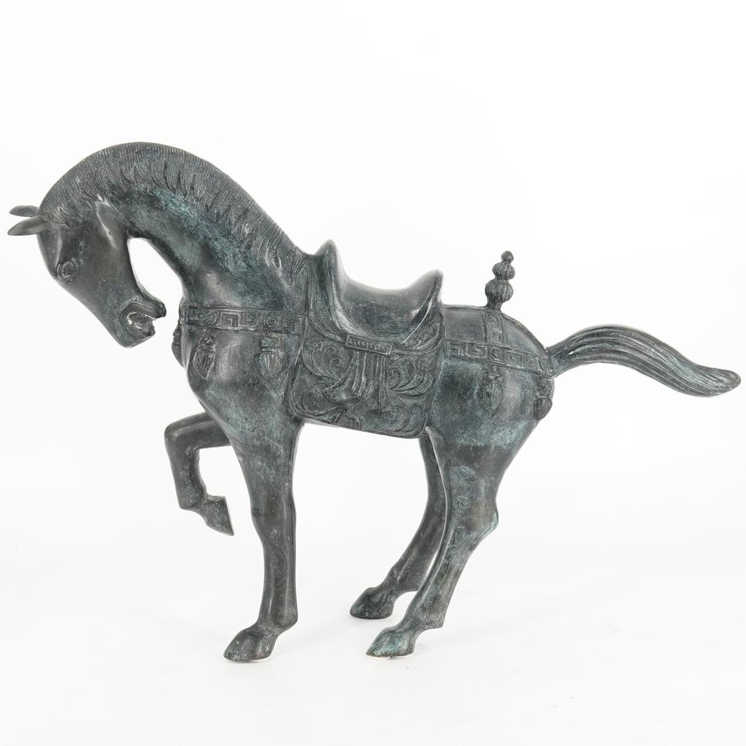 Cast Metal Horse Sculpture: DESCRIPTION: Cast Metal sculpture of a saddled horse decorated with tasseled straps embellished with key patterns. CIRCA: 20th Century ORIGIN: Continental DIMENSIONS: H: 16" W: 5.75" L: ~22.25" Have a