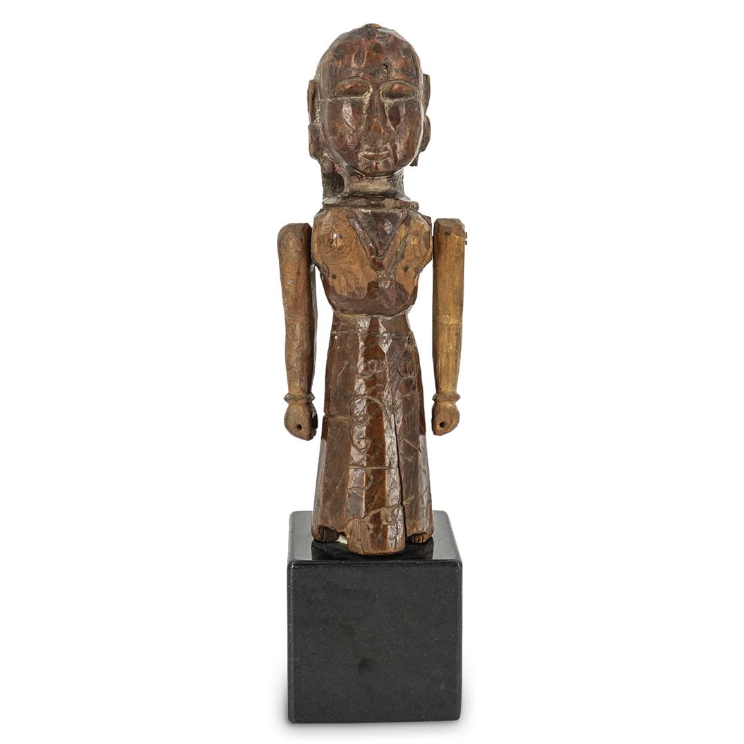 Indonesian Balinese Carved Wooden Tribal Sculpture: DESCRIPTION: A carved wooden Indonesian Balinese tribal sculpture atop a black stone pedestal base. The figure depicts a female figure with movable arms. With engraved artist signature and "Bali". CIR