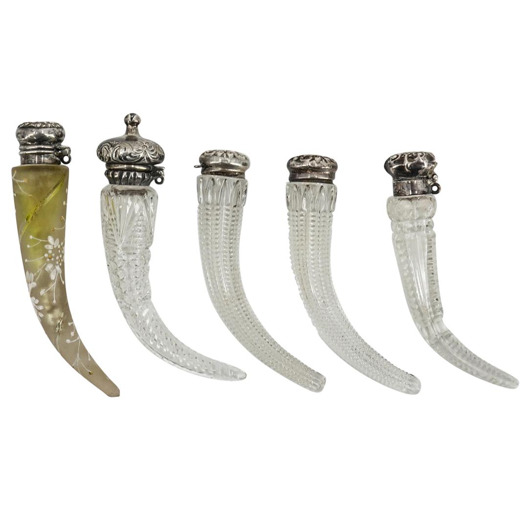(5Pc) Antique Sterling & Crystal Perfume Flasks: DESCRIPTION: 5 Antique Crystal perfume flasks with cornucopia forms, cut crystal and floral repousse sterling silver lids . (2) Hallmarked "Sterling" on top lid. (H: 3.75" X W: 1.75) (1) Hallmarked "S