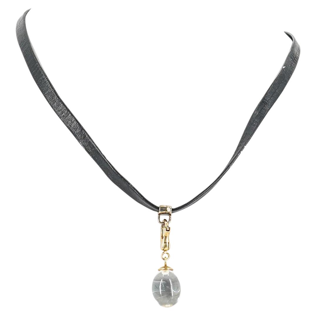 Baccarat Tentation Choker Necklace W/ Crystal Oval Pendant: DESCRIPTION: A Baccarat Tentation black leather choker necklace with a clear crystal pendant with an oval shape. (Ref. L10). CIRCA: 20th Century. ORIGIN: France. DIMENSIONS: Total length: 15". Have a 