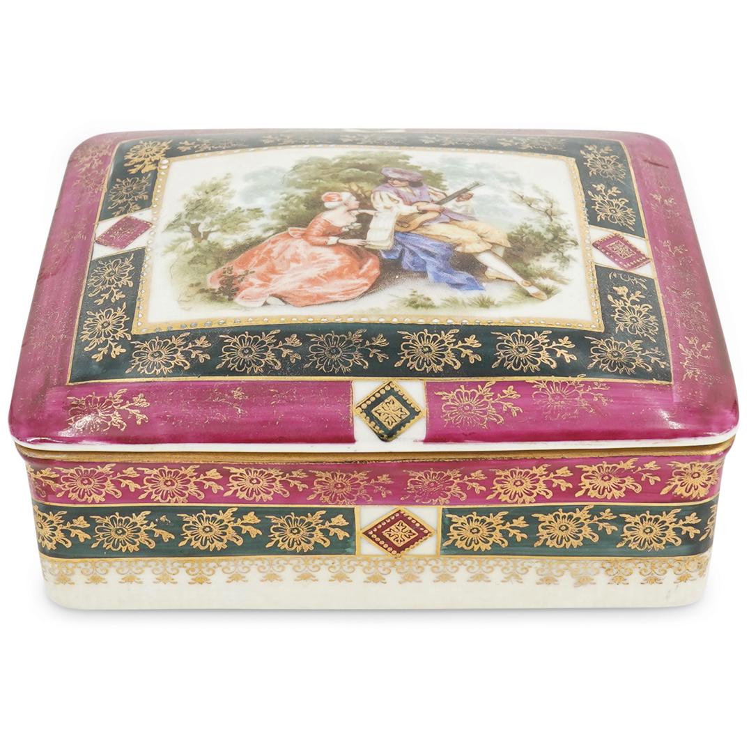 Antique Pirken Hammer Porcelain & Enamel Dresser Box: DESCRIPTION: Antique Pirken Hammer porcelain lidded dresser box with enamel depiction of woman and a musician. Features ornate floral and scroll gilt details throughout and enamel flowers inside. CIRC