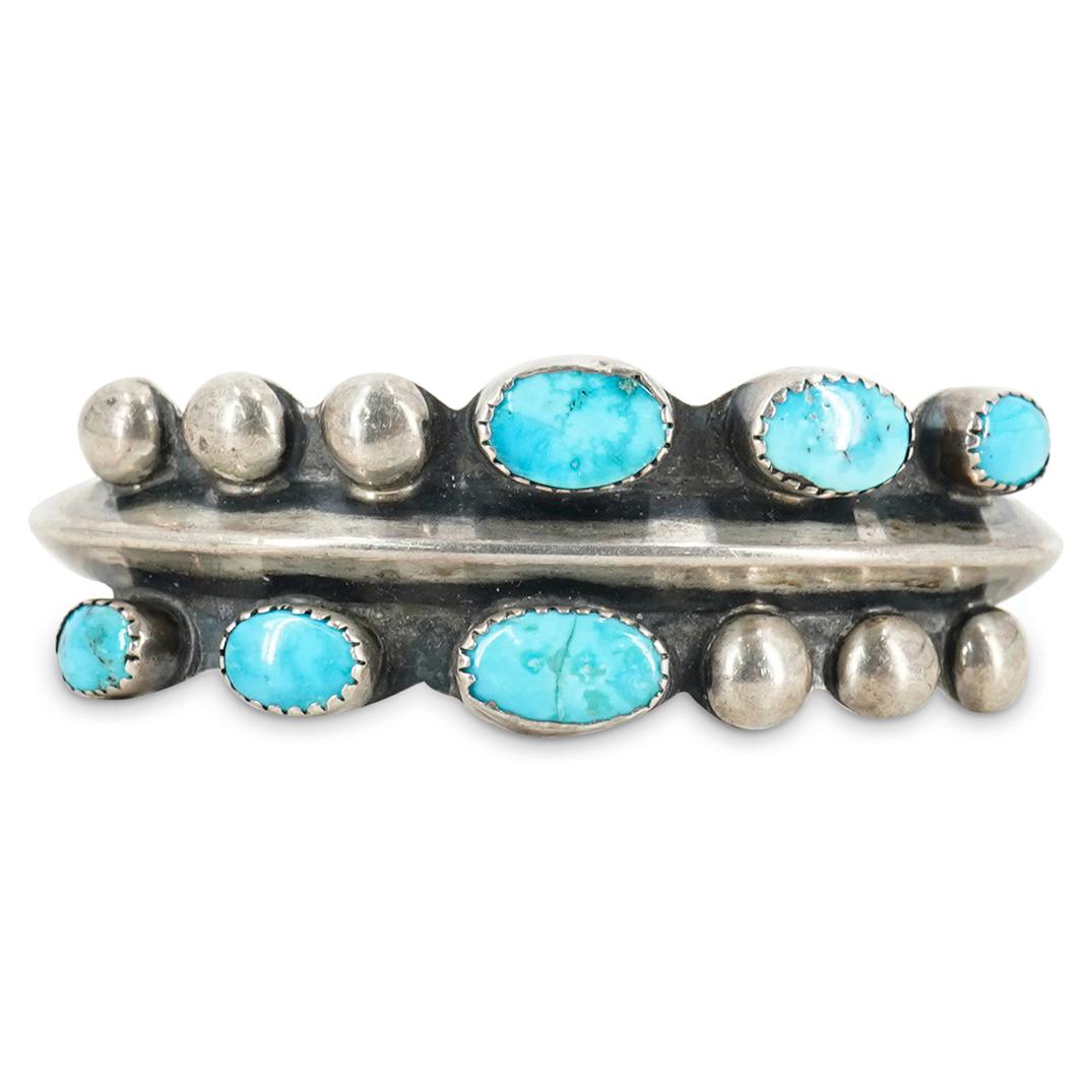 Antique Native American Sterling & Turquoise Bracelet: DESCRIPTION: Antique old pawn Native American Sterling silver bracelet with six turquoise insets and silver stud accents. Total Weight: 40 grams CIRCA: 20th Century ORIGIN: USA DIMENSIONS: D: 2.75" X