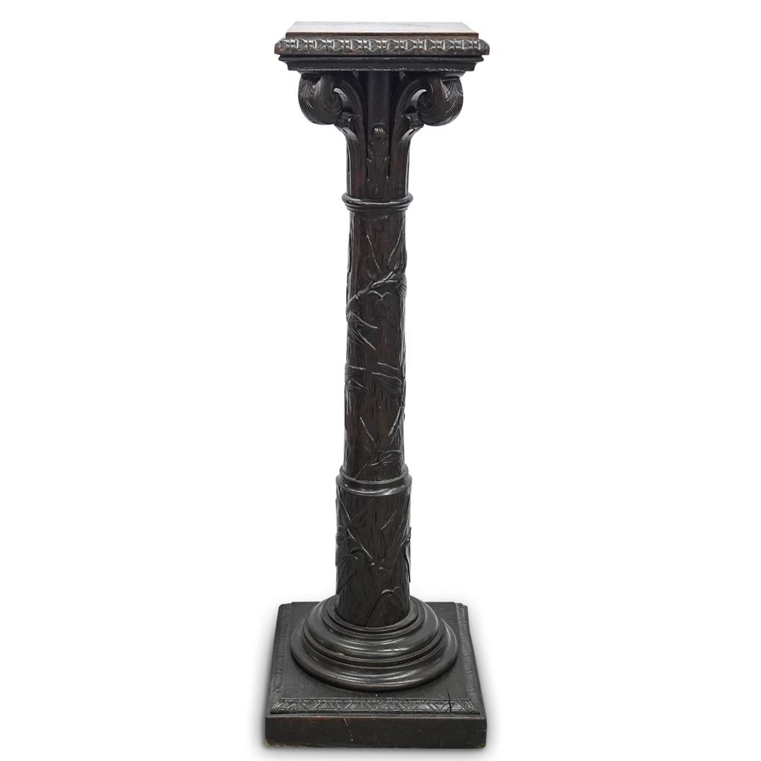French Neoclassical Carved Wood Pedestal: DESCRIPTION: French hand carved Neo-Classical wood pedestal with high relief depictions of leaves, branches and other tree details in column. Scroll relief design molding and around capital. CIRCA: 20