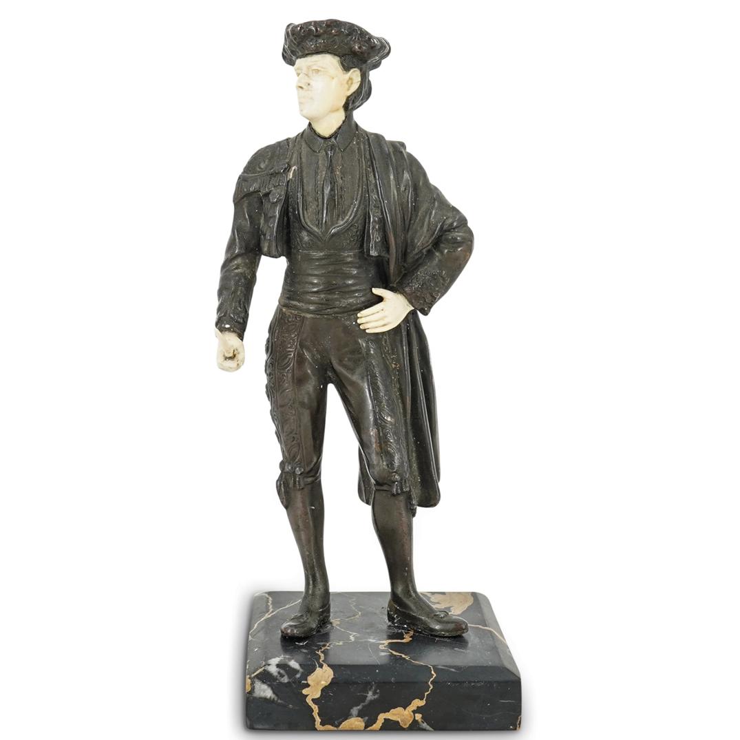 Antique Mixed Metal And Bone Matador Sculpture: DESCRIPTION: Mixed metal sculpture of a matador with a cape and blade. Piece is embellished with hands, a face, and a neck made of bone and is mounted on a hard stone base. CIRCA: Early 20th Century O