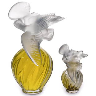 (2 Pc) Lalique "L'Air du Temps" Nina Ricci Perfume Bottles: DESCRIPTION: (2 Pc) A Pair of Lalique crystal "LAir du Temps" factice display perfume bottles for Nina Ricci. Designed with a double dove birds stopper. Marked "Lalique" on the underside. CIRCA: 20th