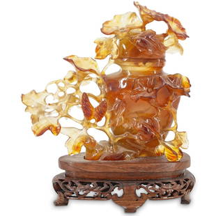 Chinese Agate Hand Carved Urn: DESCRIPTION: Chinese agate urn surrounded by carved open-work floral and foliage decorations of one piece with the urn and its lid. Mounted on custom wooden stand decorated with open-work skirt. CIRCA