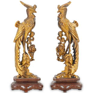 Pair Of Chinese Tiger Eye Phoenix Sculptures: DESCRIPTION: Two tiger eye sculptures, each depicting a Chinese phoenix (fenghuang) perched on a flowering branch. Pieces are each mounted on a reticulated wooden stand decorated with gilt meandering