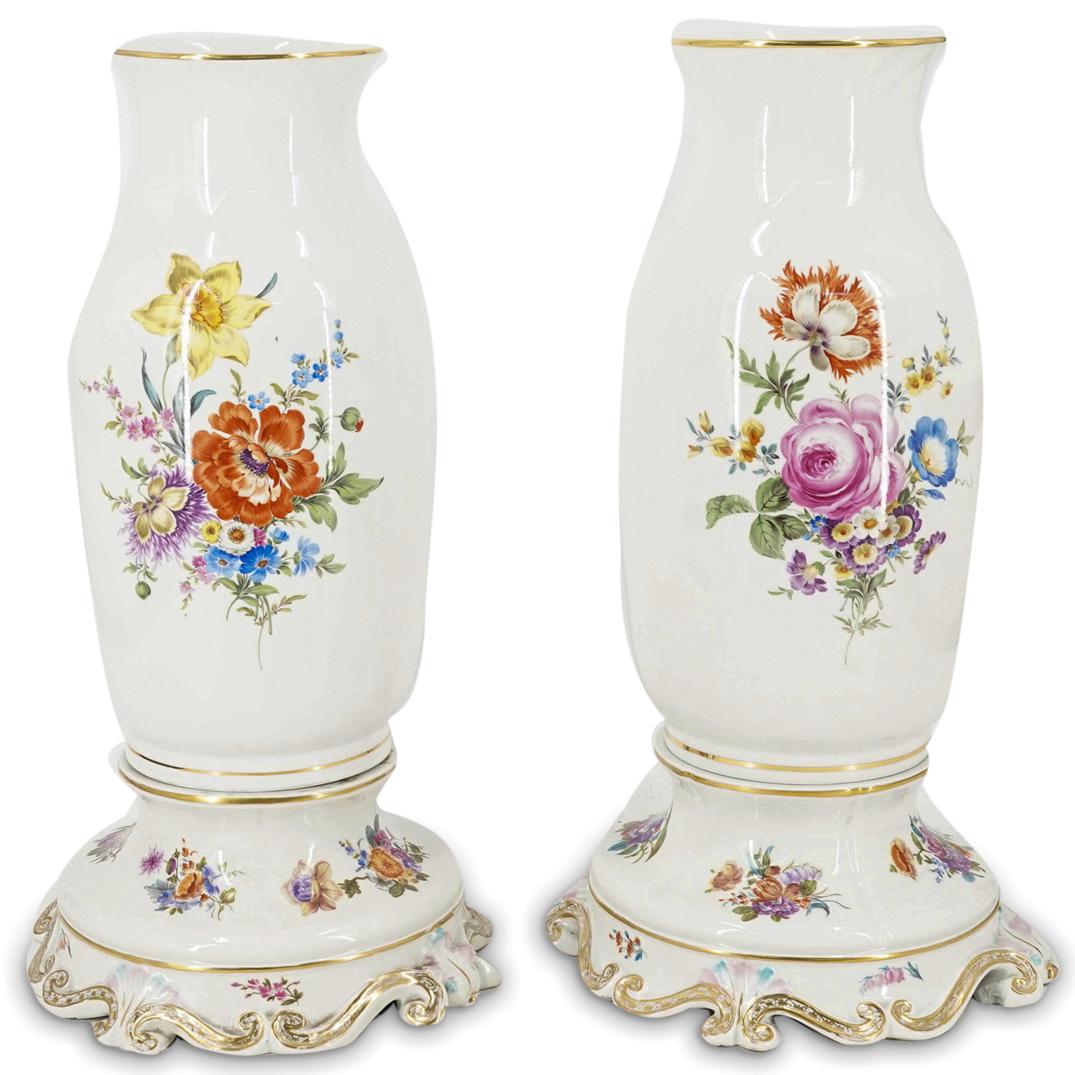 Pair of Meissen Porcelain Vases: DESCRIPTION: A pair of German Meissen porcelain vases with hand painted floral bouquets, mounted toi ornate gilt lined display bases. Meissen crossed sword marks at underside.Provenance:Long Island Po