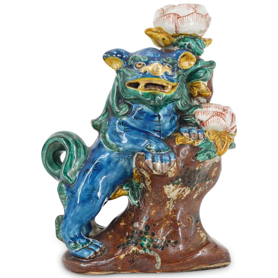 Chinese Qing Sancai Glazed Pottery Foo Dog Figural Candle Holder: DESCRIPTION: A chinese Qing period Sancai glazed pottery foo dog figural candle holder. The figure stands resting its front paws on a large tree trunk. The dog has its customary open mouth revealing i
