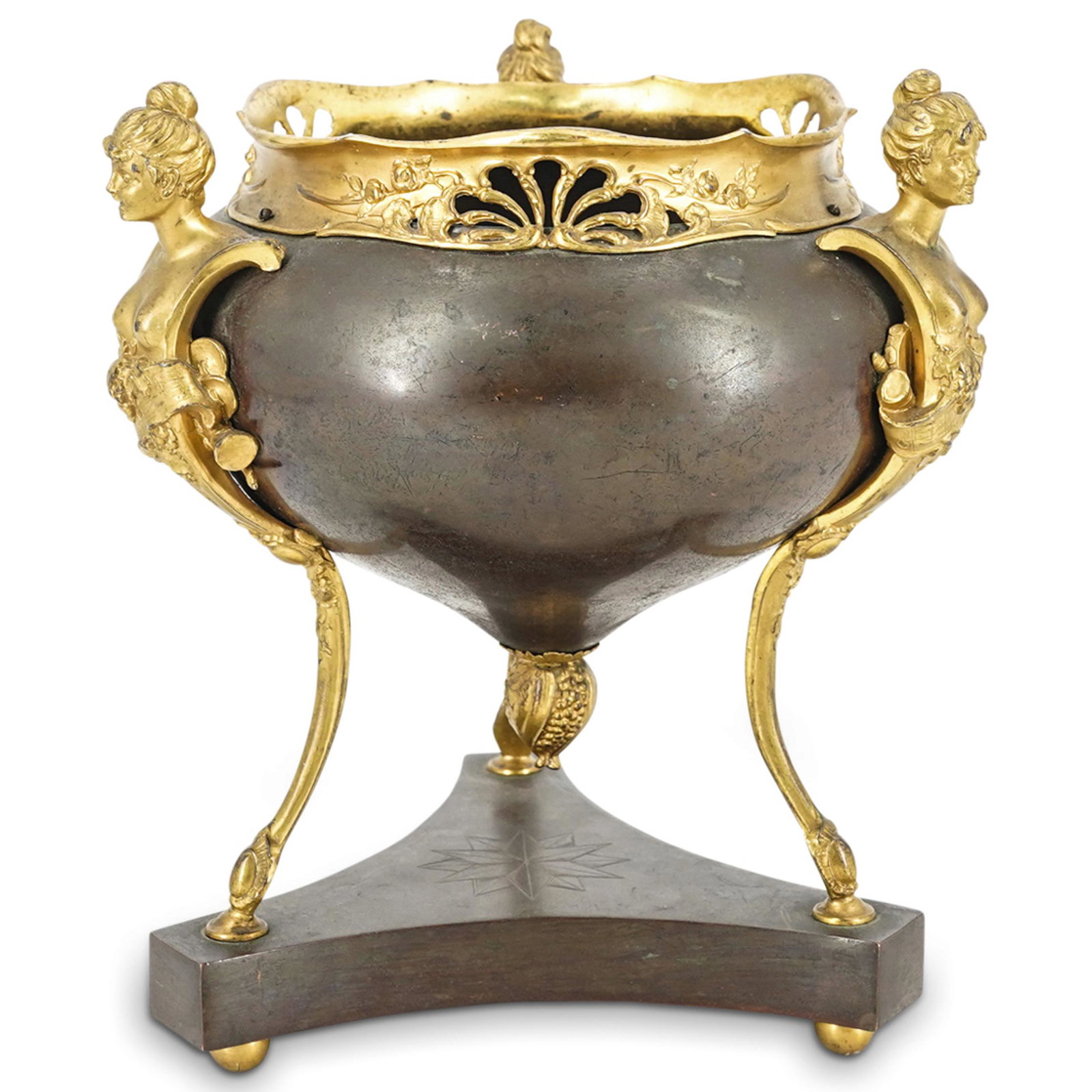 French Bronze Tripod Urn: DESCRIPTION: Bronze urn supported by three gilt legs featuring female bust, grapevine, and music sheet designs. Each leg supporting the urn is mounted on a tripod base marked with a twelve-pointed sta