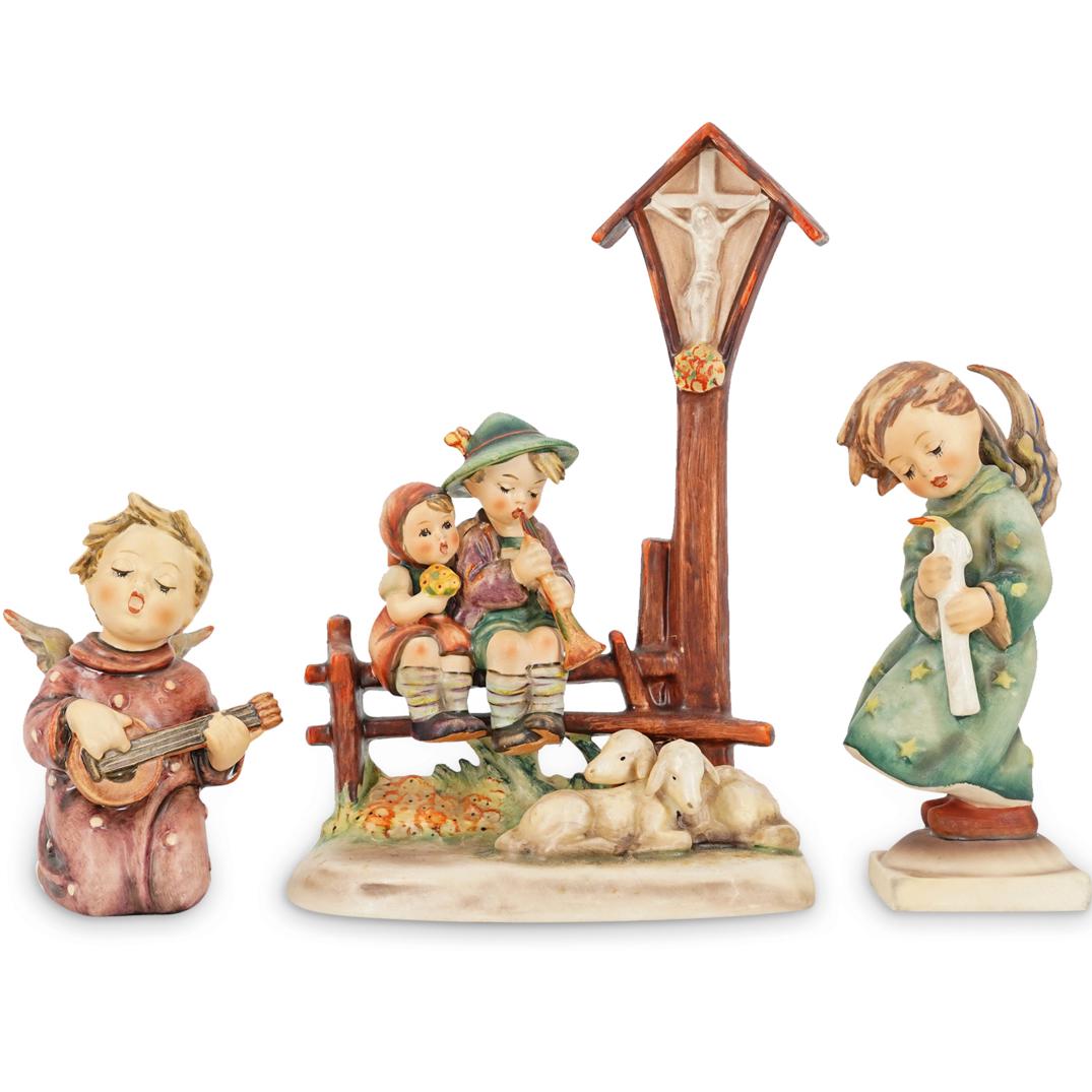 (3 Pc) Goebel Porcelain Figurines Grouping Set: DESCRIPTION: (3 Pc) A Goebel porcelain figurines grouping set. This set includes the following figurines: (1 Pc) "Heavenly Angel", model # (H: 6") (1 Pc) "Serenade" Angel with guitar, model #260B ( H: