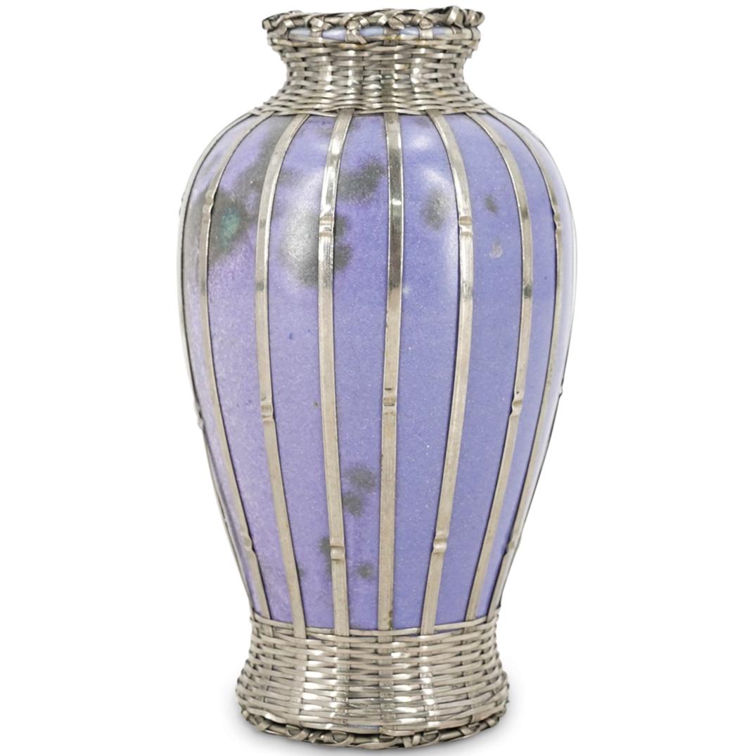 Japanese Meiji Silver Weave Art Pottery Vase: DESCRIPTION: Japanese Meiji period lavender hue pottery vase wrapped in silver basket weave. CIRCA: Late 19th to Early 20th Century ORIGIN: Japan DIMENSIONS: H: 5" X D: 3.75" CONDITION: Great conditio