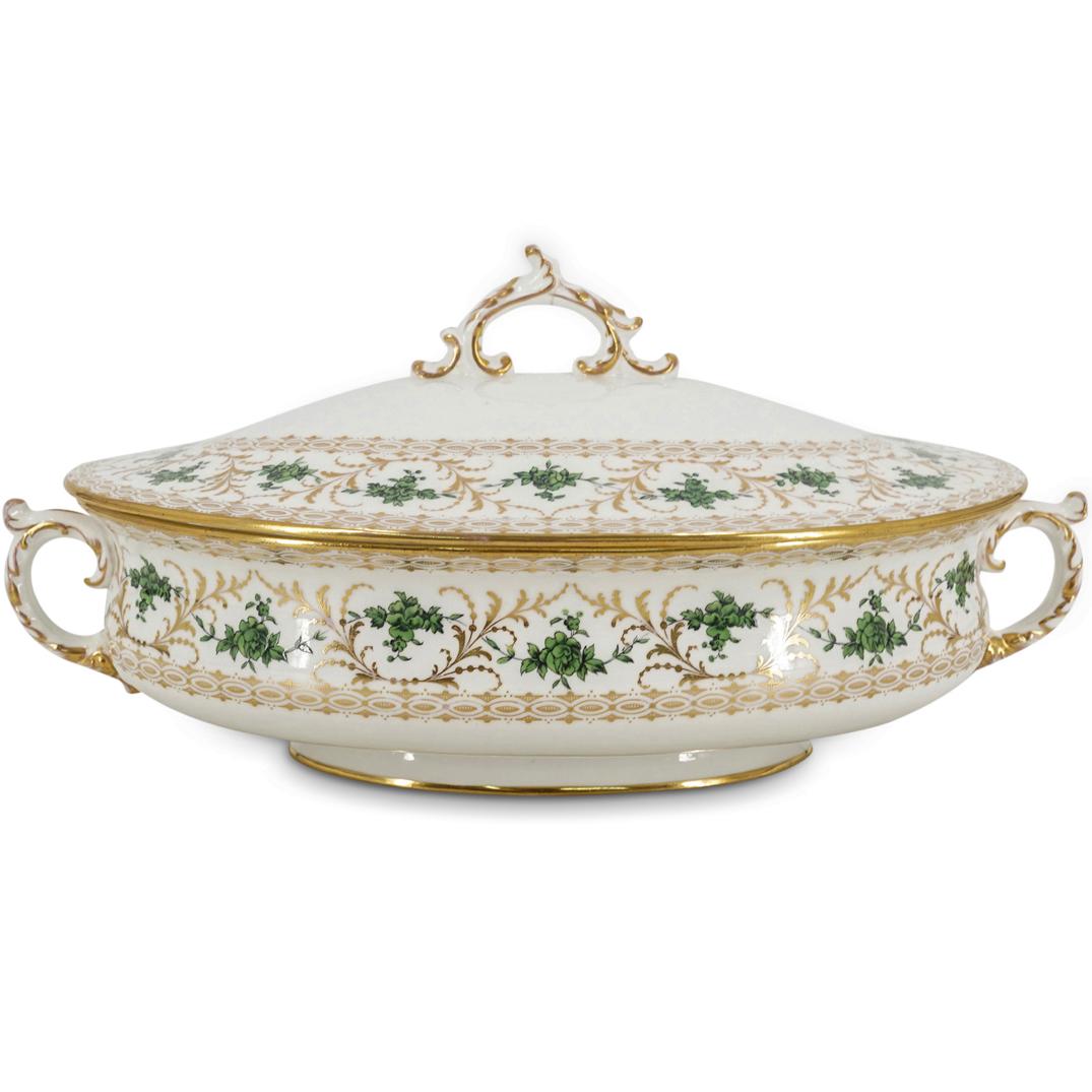 Wedgwood Gilt Porcelain Tureen: DESCRIPTION: Wedgwood double handled tureen gilt throughout with floral designs and ring patterns, has enamel depictions in green of foliage. CIRCA: 20th Century ORIGIN: England DIMENSIONS: H: 5.5" X 