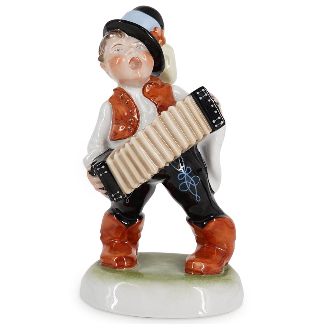 Herend Porcelain Boy With Accordian: DESCRIPTION: Herend porcelain sculpture depicts a young boy playing an accordian, completed with realistic painted details. Stamped along the underside with Herend marks. CIRCA: 20th Cent. ORIGIN: Hun