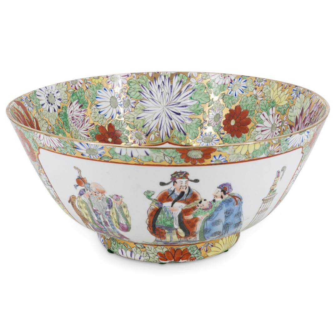 Chinese Rose Medallion Porcelain Bowl: DESCRIPTION: Rose medallion bowl decorated with images of he Sanxing standing together next to a brush pot on a table. Piece is embellished with floral motifs against a gilt background. Image inside o