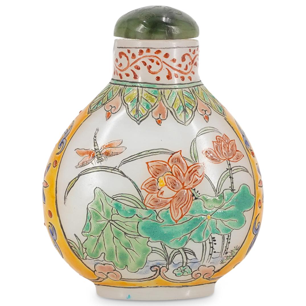 Antique Chinese Xuan Glass Enameled Snuff Bottle: DESCRIPTION: Antique enameled xuan glass snuff bottle with fine depictions of flowers throughout and a jade stopper. Marked "Guyue Xuan" in kanji at the underside. CIRCA: 20th Century ORIGIN: China DI