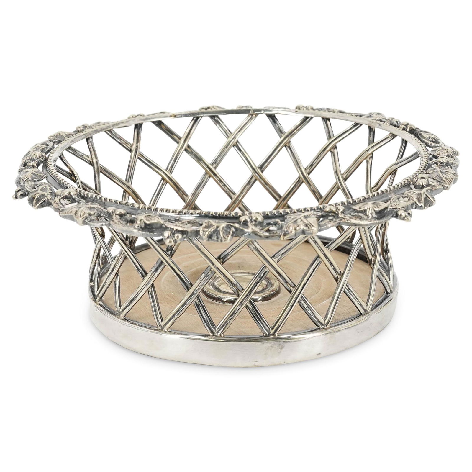 English Sterling Silver Open Work Wine Coaster: DESCRIPTION: An english Sheffield Sterling Silver wine coaster with reticulated design and a wooden base. Hallmarked. CIRCA: Late 19th-Early 20th Century ORIGIN: England. DIMENSIONS: H: 2 1/2" W: 7".