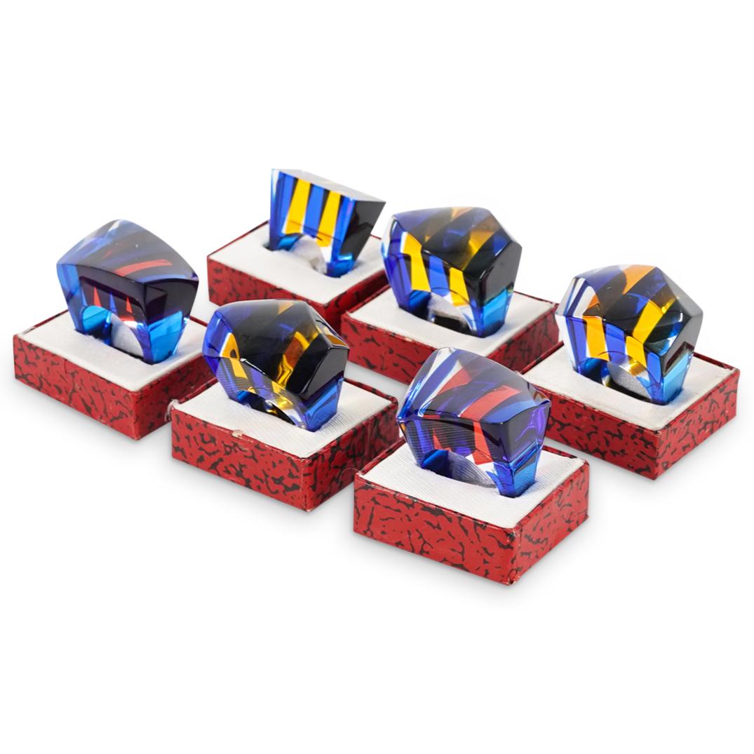 (6 Pc) Lucite Rings: DESCRIPTION: Six lucite rings and decorated with either blue, orange and clear stripes or blue, red, and clear stripes. Each piece comes in its original box. CIRCA: 20th Century ORIGIN: USA DIMENSIONS