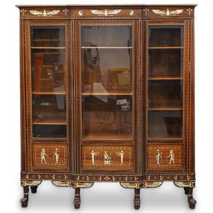 Ex-Sotheby's Carlo Bugatti Attrib. Egyptian Revival Inlaid Breakfront Cabinet: DESCRIPTION: Ex-Sotheby's Carlo Bugatti attributed Egyptian revival breakfront cabinet. Features a lacquered wood foundation with three hinged glass panel doors, supported by animalistic paw and knob