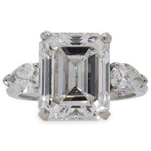 GIA 7.94ct Diamond and Platinum Engagement Ring: DESCRIPTION: GIA certified 7.94ct Emerald Cut Diamond featuring J color and SI1 Clarity (Per GIA report), mounted atop a Platinum ring, flanked on either side by .50 ct Pear cut VS2 Diamonds. Stamped