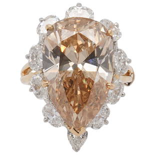 GIA 10.83ct Brown-Orange Diamond and 18k Gold Ring: DESCRIPTION: GIA certified 10.83 Pear Brilliant cut Diamond featuring Natural Fancy Brown-Orange Color and SI1 Clarity (Per GIA Report), encompassed by (9) VS2 White Pear cut Diamonds each weighing