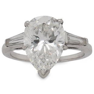 GIA 3.22ct Pear Brilliant Diamond and Platinum Engagement Ring: DESCRIPTION:A GIA certified 3.22ct Pear Brilliant cut Diamond featuring G color and VS2 Clarity (Per GIA Report), mounted into a Platinum setting flanked on either side by Baguette cut Diamonds.