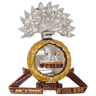 Egypt Lancashire Fusiliers Palladium, Gold, Diamond Sweetheart Brooch: DESCRIPTION: Egypt Lancashire Fusiliers military brooch composed of palladium and 18k gold with inset diamonds and enameling, completed by a retractable bail, pinstem, and catch on the reverse.